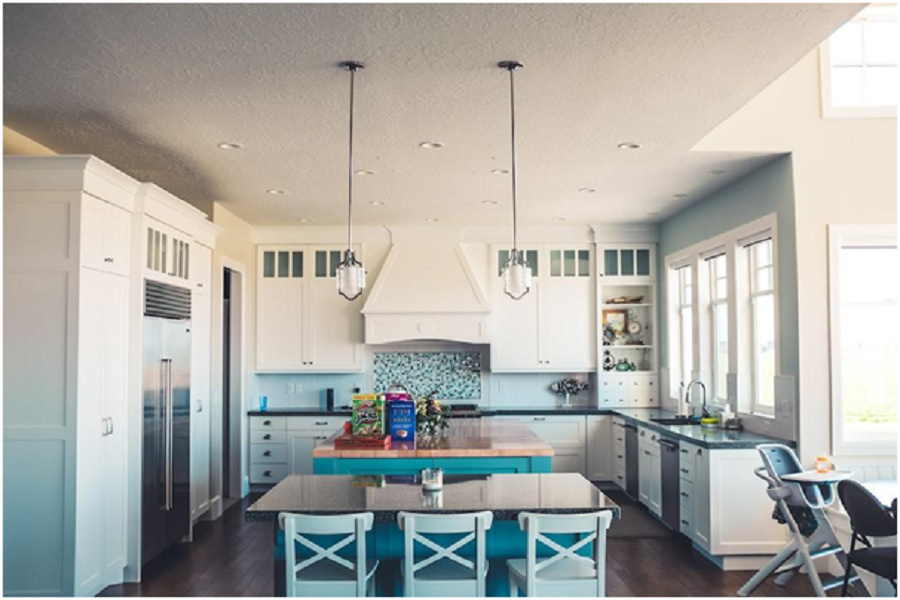 A kitchen with a blue tile splash. 