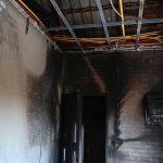 old scary interior burn house, cement wall and wood floor