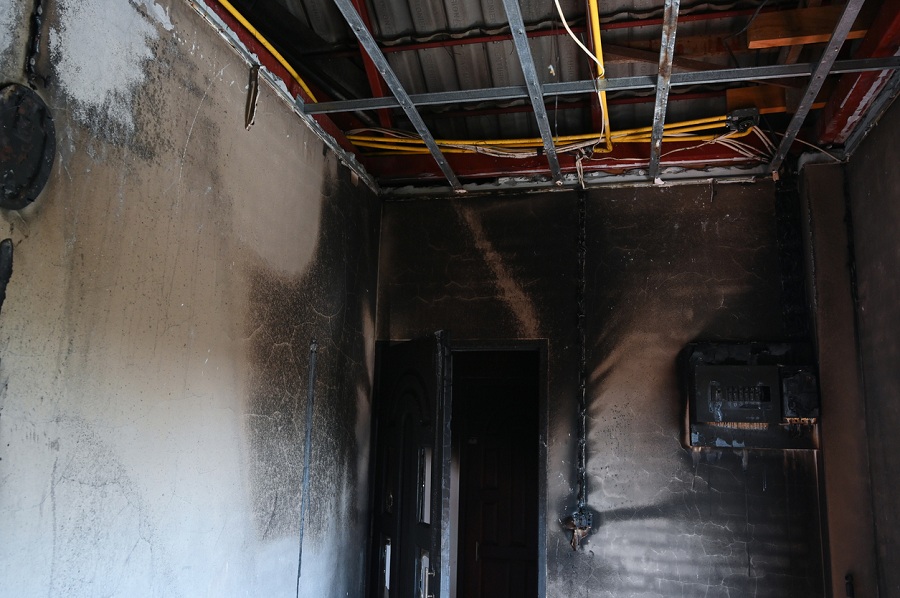 old scary interior burn house, cement wall and wood floor
